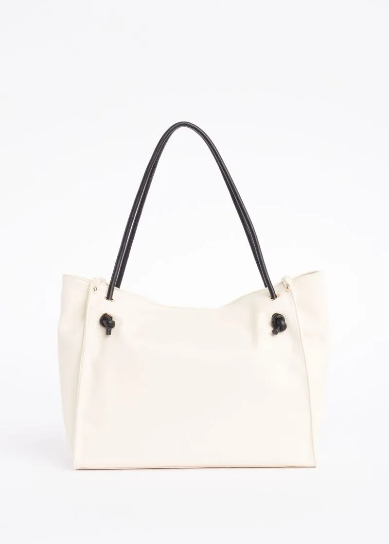 Borsa shopper con occhielli e borchie